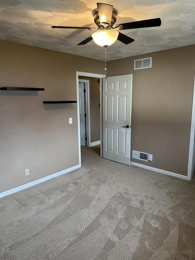 carpeted empty room with ceiling fan