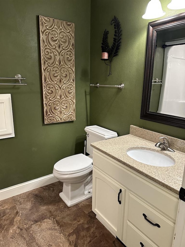 bathroom featuring vanity and toilet