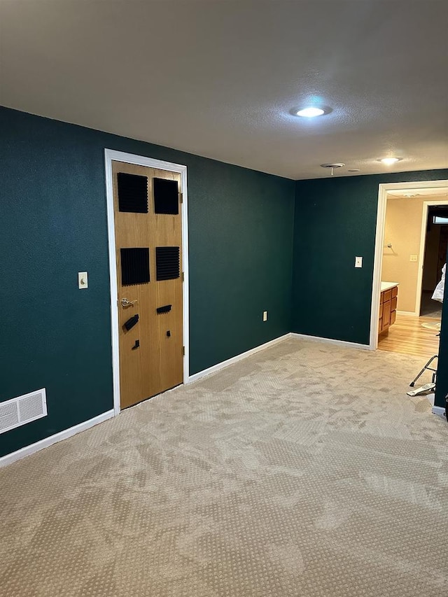 empty room with light colored carpet