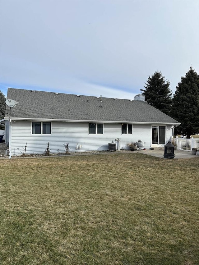 back of property with a yard, a patio, and central AC unit