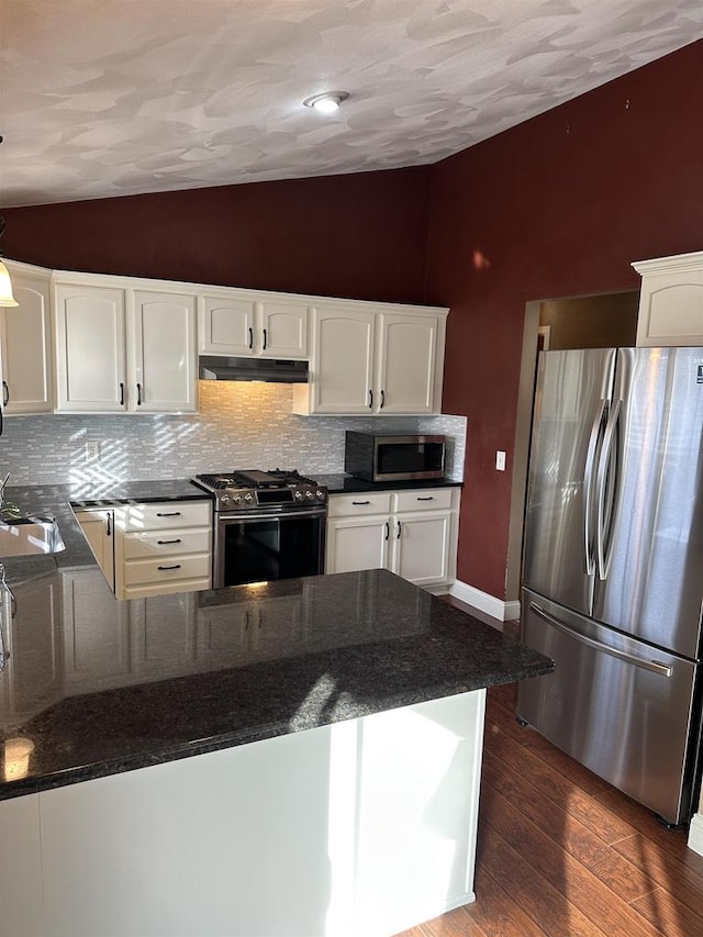 kitchen featuring kitchen peninsula, appliances with stainless steel finishes, and white cabinets