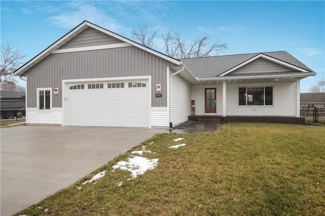 ranch-style home featuring fence, board and batten siding, concrete driveway, a front yard, and a garage