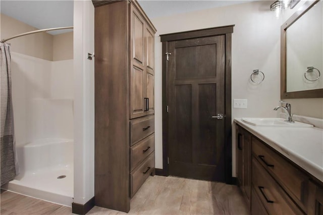 bathroom with curtained shower and vanity