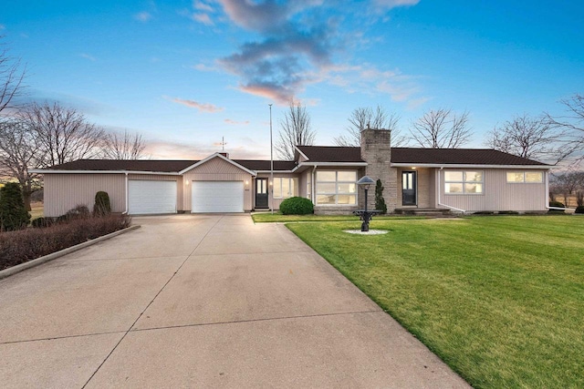 single story home with a garage and a lawn