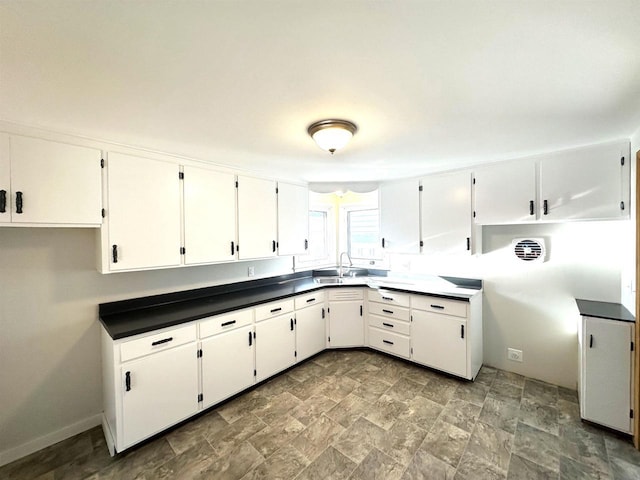 kitchen with white cabinetry and sink