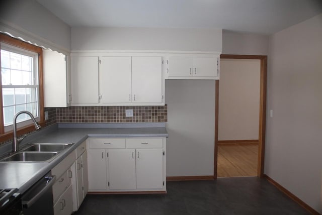 kitchen with dishwasher, white cabinets, range with electric cooktop, sink, and decorative backsplash