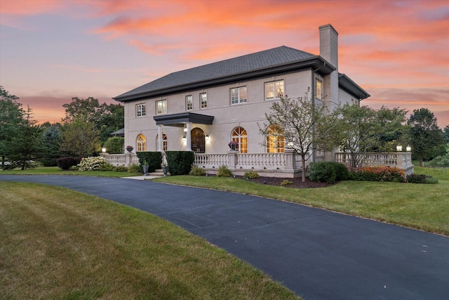 view of front of house featuring a lawn and a porch