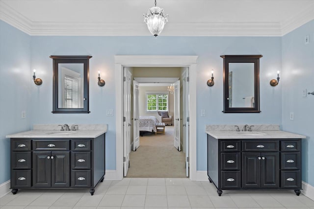 bathroom featuring crown molding, vanity, and a chandelier