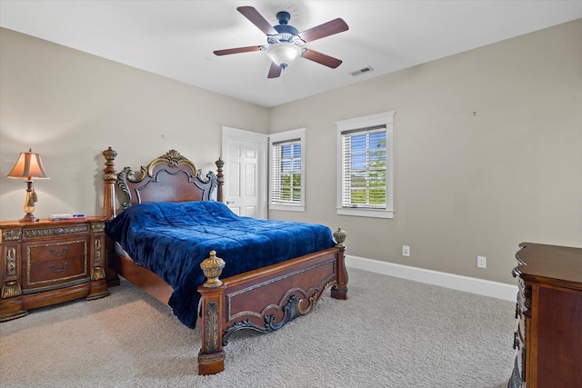 bedroom with ceiling fan and light carpet