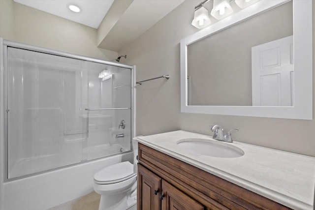 full bathroom featuring vanity, bath / shower combo with glass door, and toilet