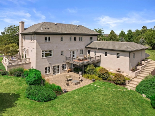 rear view of house featuring a yard, a patio area, and a wooden deck