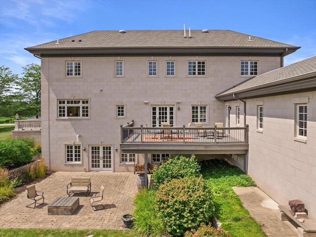 back of property with a patio, a wooden deck, and french doors