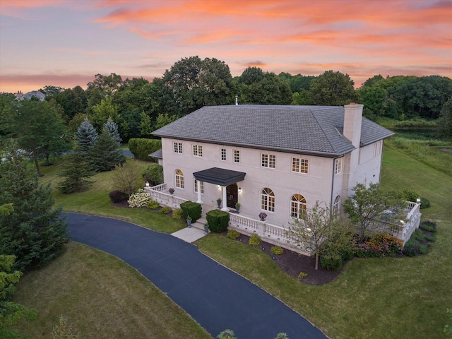 colonial-style house with a lawn