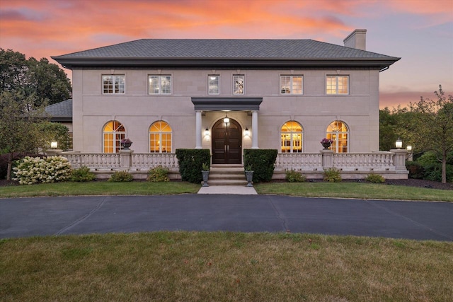 view of front of house with a lawn and a porch