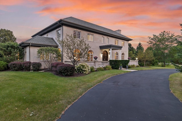 view of front of house featuring a lawn and covered porch