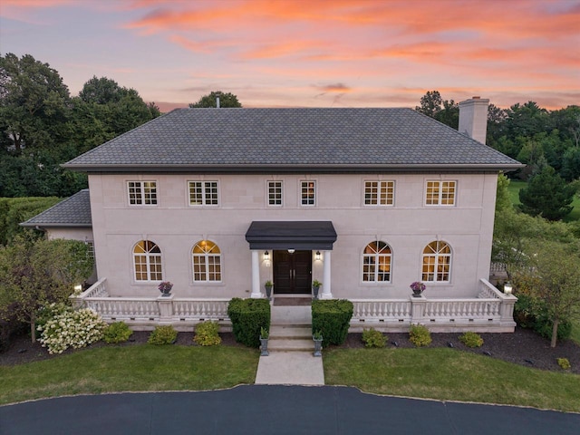 view of front of house featuring a yard and covered porch