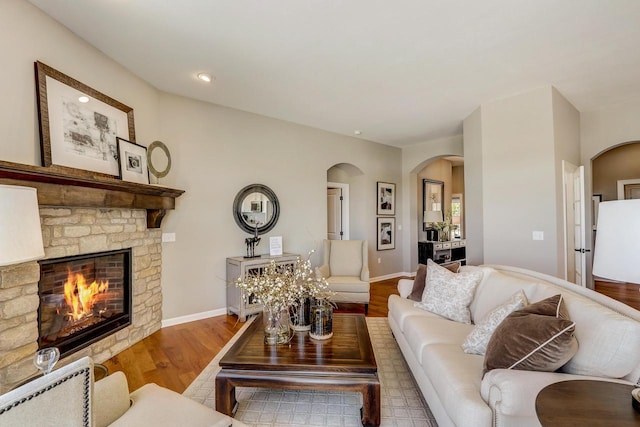 living room with a fireplace and light hardwood / wood-style flooring