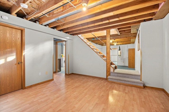 basement with hardwood / wood-style floors