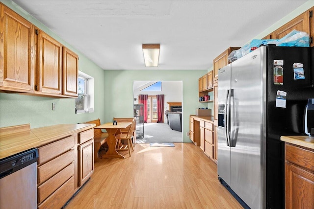 kitchen featuring appliances with stainless steel finishes and light hardwood / wood-style flooring