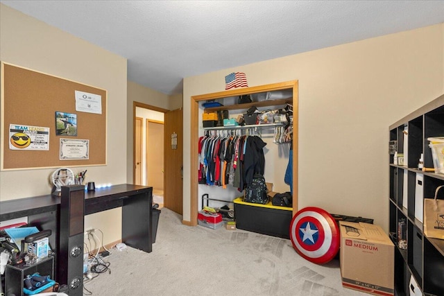 office area with a textured ceiling and light carpet