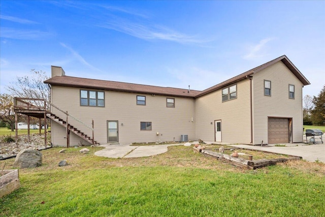 back of property with a patio area, a yard, a wooden deck, and a garage