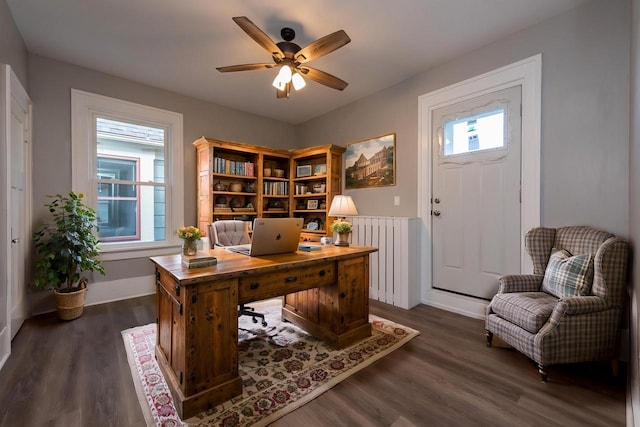 office with ceiling fan, dark hardwood / wood-style flooring, and radiator heating unit