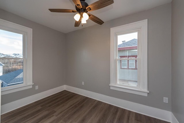 empty room with ceiling fan and dark wood-type flooring