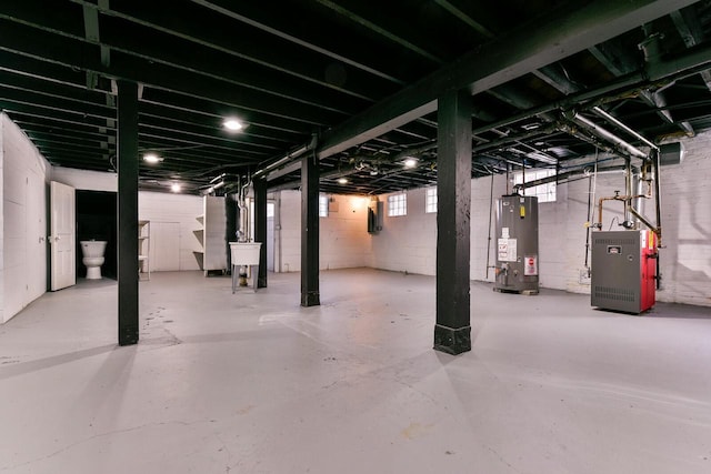 basement with gas water heater and sink