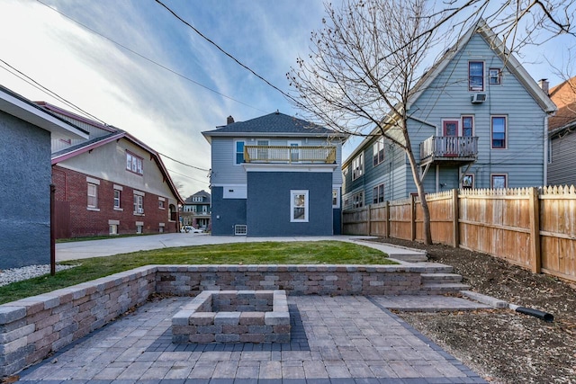 back of house featuring a patio and a fire pit