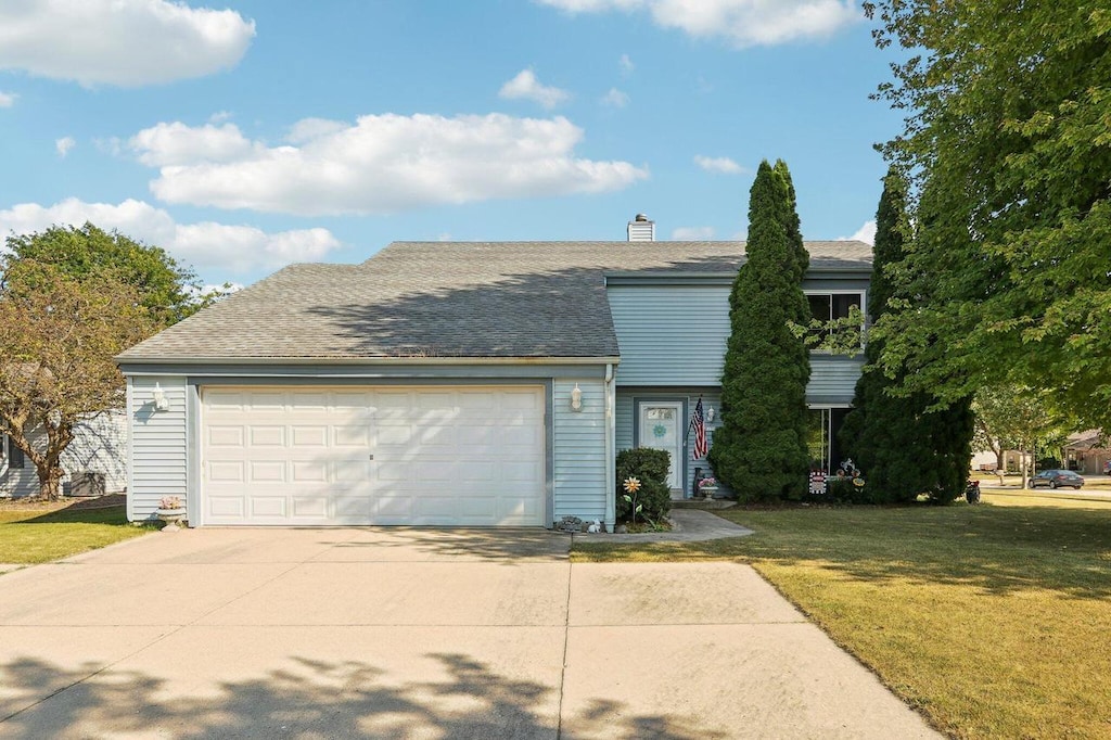 view of front facade with a garage and a front yard