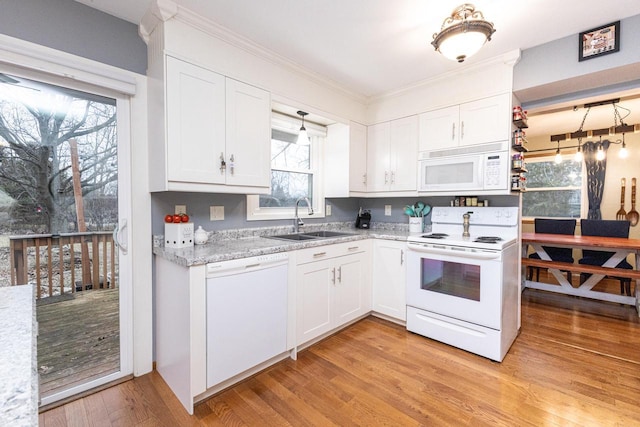 kitchen featuring white cabinets, white appliances, light hardwood / wood-style flooring, and sink