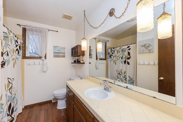 bathroom featuring hardwood / wood-style floors, vanity, and toilet