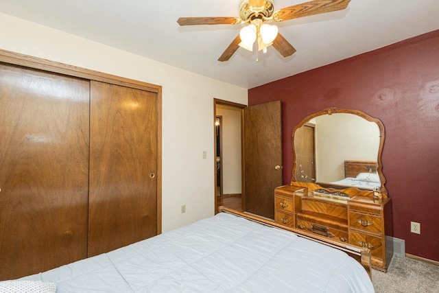 bedroom with ceiling fan, a closet, and carpet floors