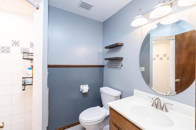 bathroom featuring vanity, toilet, and walk in shower