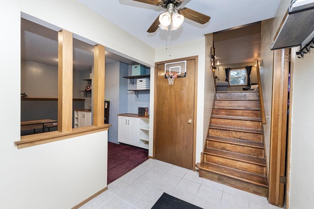 stairway with tile patterned flooring and ceiling fan