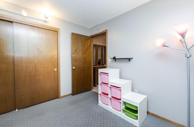 unfurnished bedroom featuring light carpet and a closet