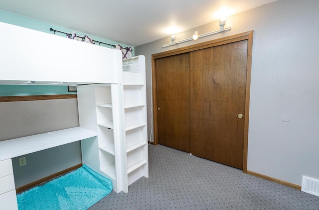 walk in closet featuring light carpet