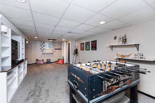 playroom with a paneled ceiling and carpet floors