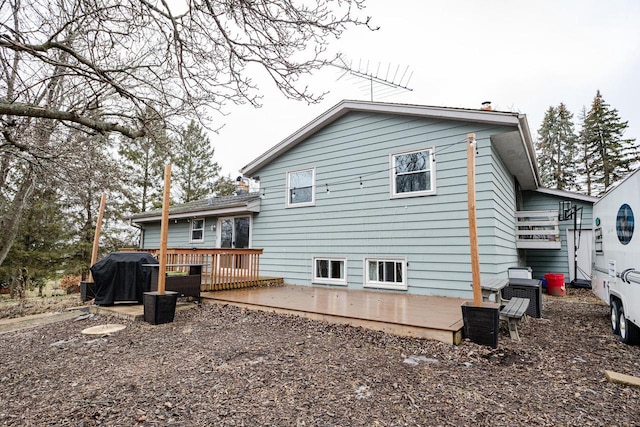 rear view of property with a wooden deck