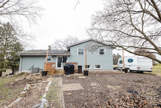 rear view of property featuring central air condition unit