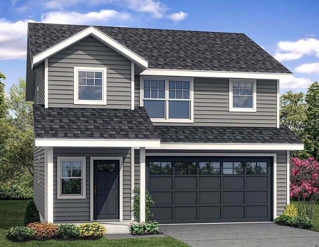 view of front of house with a garage and a front lawn