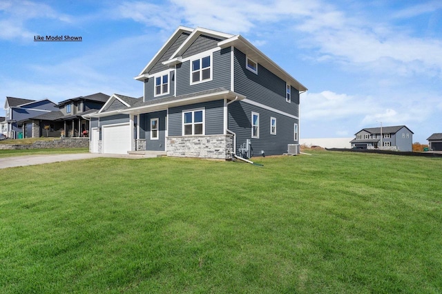 craftsman-style house featuring central AC unit, a garage, and a front yard