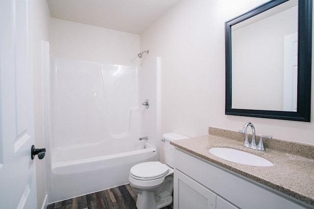 full bathroom with shower / washtub combination, hardwood / wood-style floors, vanity, and toilet