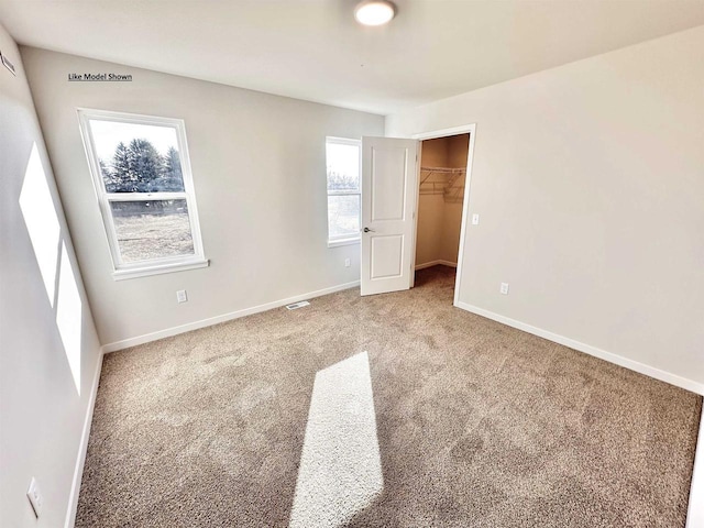 carpeted spare room with plenty of natural light