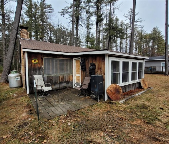 rear view of house with a wooden deck