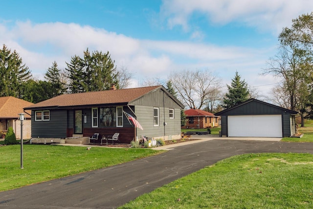 ranch-style home featuring an outbuilding, a front lawn, and a garage