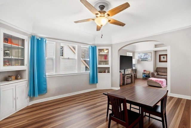 dining space featuring ceiling fan, dark hardwood / wood-style floors, and crown molding