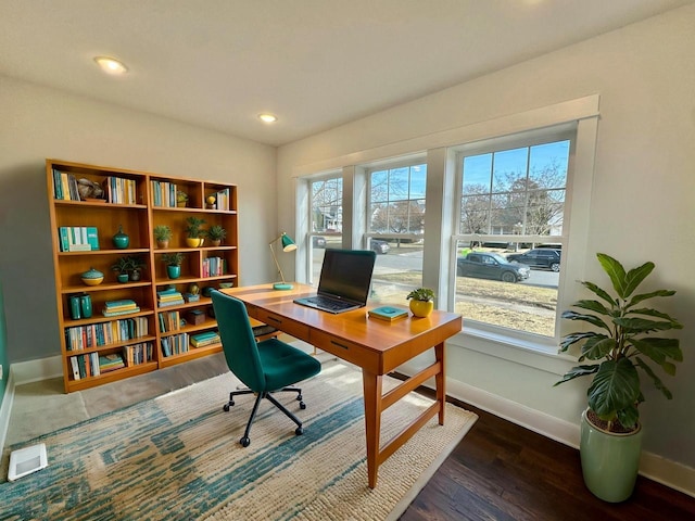 home office with dark hardwood / wood-style floors