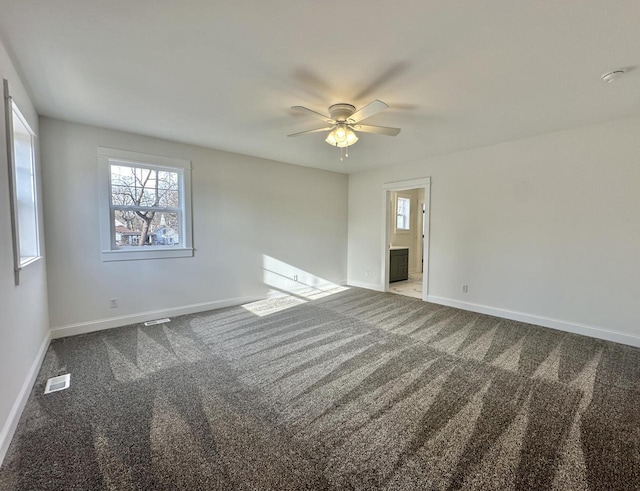 carpeted spare room featuring ceiling fan