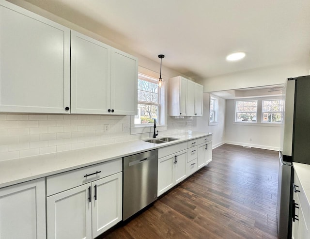 kitchen with white cabinetry, sink, tasteful backsplash, pendant lighting, and appliances with stainless steel finishes